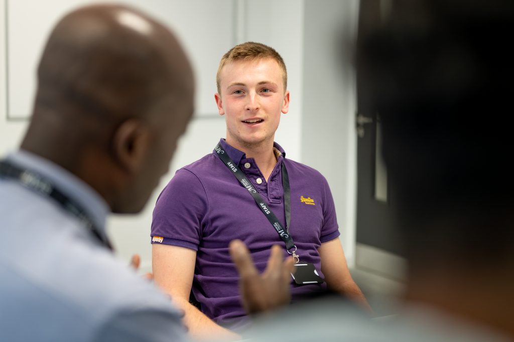 Student and teacher talking in a classroom at Morley College North Kensington