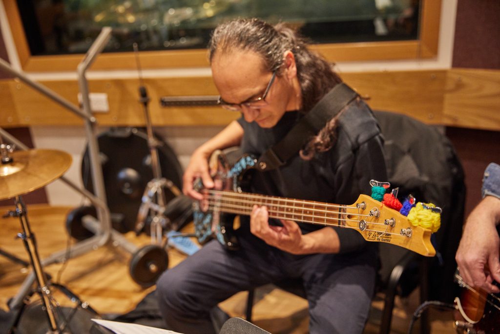 Student playing on a bass guitar