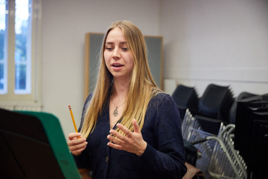 Woman performing opera in class